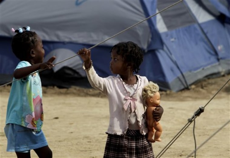 Two Haitian children are seen at a camp for earthquake survivors set up by Michael Capponi, a Miami property developer, in Port-au-Prince, Wednesday, March 3, 2010.  A magnitude-7 earthquake struck Haiti last Jan. 12.  (AP Photo/Ramon Espinosa)